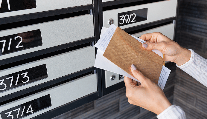 happy-girl-picks-up-her-bills-and-letters-from-her-2025-02-10-09-55-14-utc